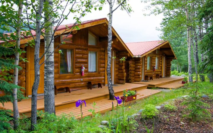 Log cabins at the Kantishna Roadhouse are situated near a meandering creek below the Alaskan Range in Denali National Park.