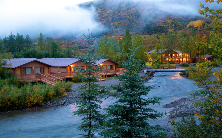 Creekside cabins in the forest at the foot of a mountain in Denali National Park at Denali Backcountry Lodge in Kantishna, Alaska