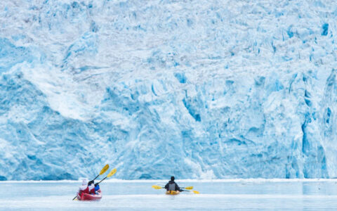 Two kayaks on the open water of the Kenai National Park in front of a glacier in Alaska where the backcountry shines the brightest