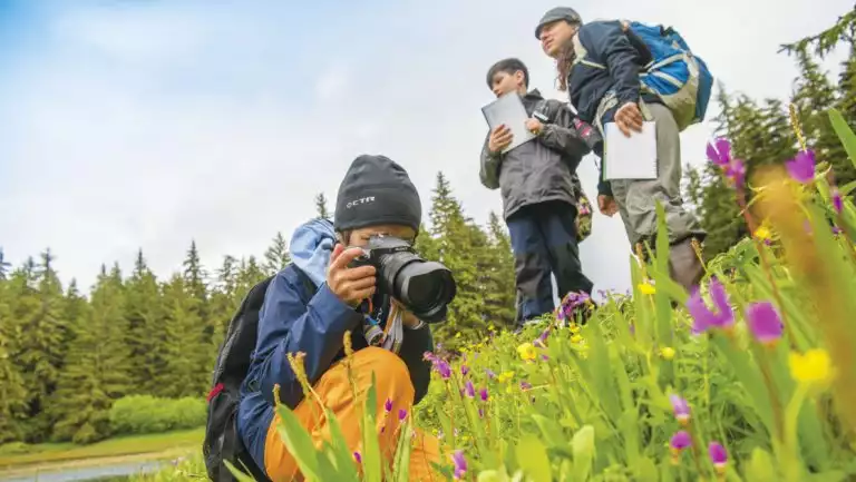 Kids working on Global Explorers field notebook on the Lake Eva Trail in SE Alaska.