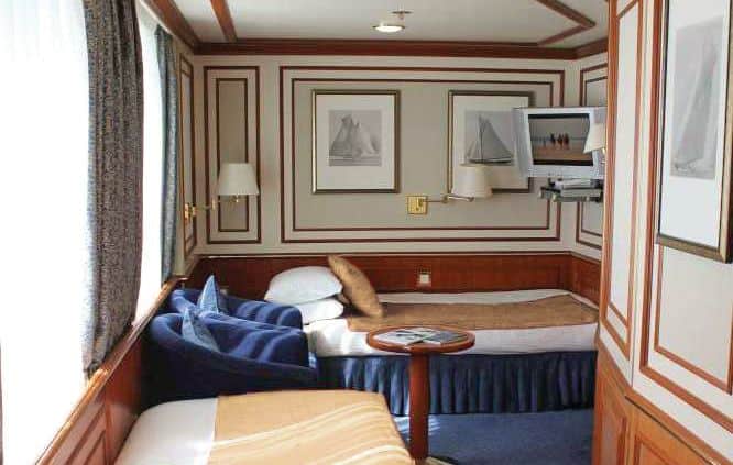Cat 3S Suite with Window #512. This solo suite features two beds and two large windows, plus two armchairs and small table, reading lamps, a flat screen TV, and climate controls.