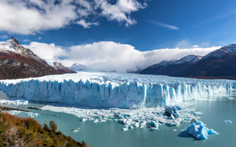 Massive diamond-shaped glacier of white & blue tumbles into a turquoise lake of glacial silt, seen on Explora El Chaltén.