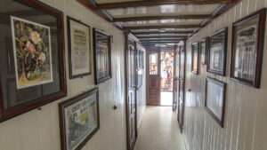 pictures and artwork hang on the interior walls of the Tucano ship