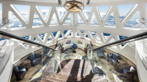 Xbow ship with a comfortable lounge looking out onto the sunny icebergs aboard douglus mawson