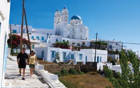 a couple from the small ship cruise take a walking tour along the greek isles