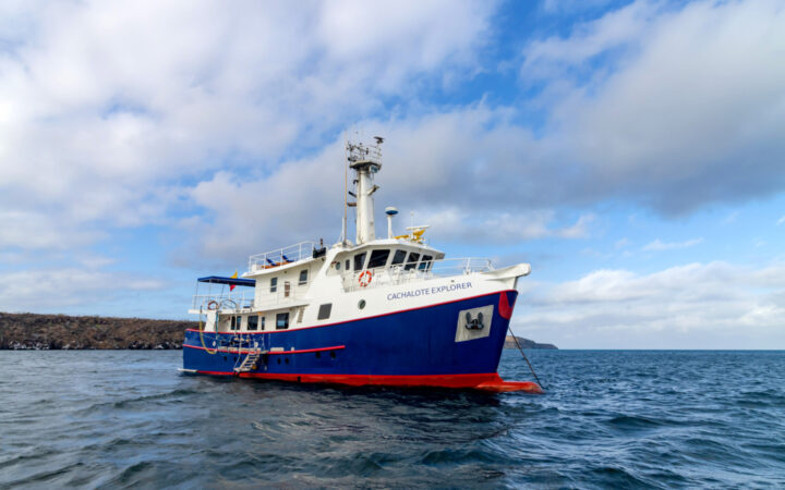 Exterior shot of cachalote explorer saliing through the Galapagos Islands on a sunny but cloudy day