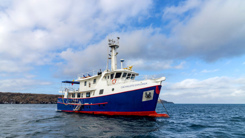 Exterior shot of Cachalote Explorer saliing through the Galapagos Islands on a sunny but cloudy day