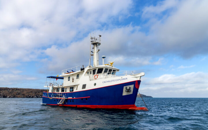 Exterior shot of Cachalote Explorer saliing through the Galapagos Islands on a sunny but cloudy day