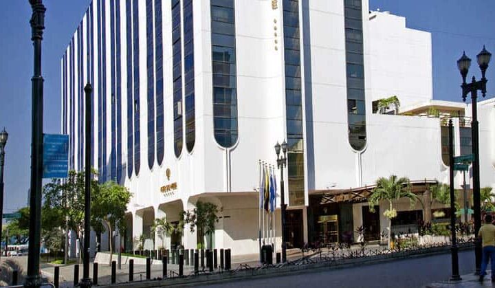 The exterior of the white, high-rise building that is the Hotel Oro Verde, located in downtown Guayaquil, Ecuador