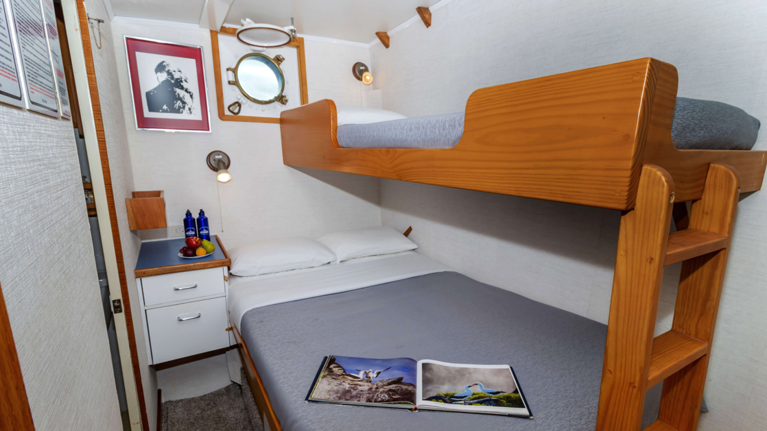 Cabins 3, 4, & 7 aboard Cachalote Explorer with bunk beds and porthole.