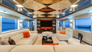 Living room with white couches and orange pillows