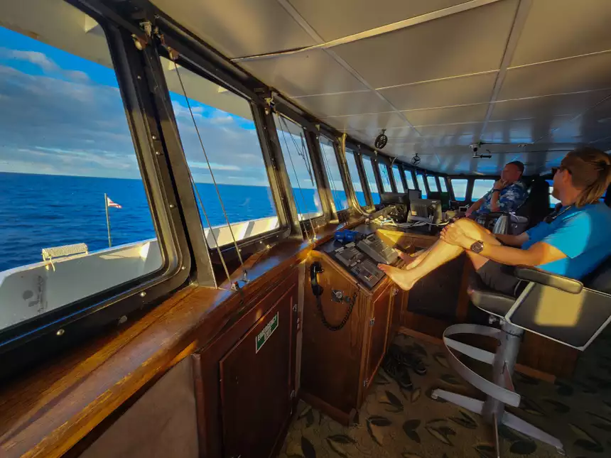 viewing point of Bridge of small ship with captain and crew looking out