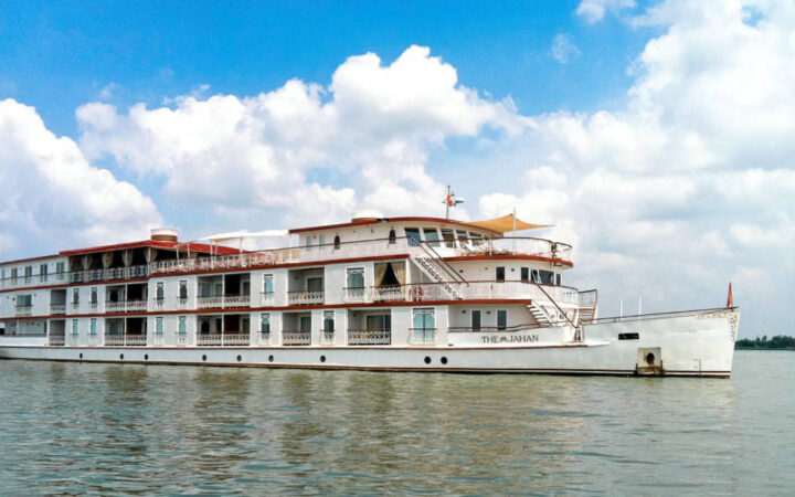 Jahan exterior anchored in Southeast Asia in calm waters and blue skys with white fluffy clouds as a backdrop.