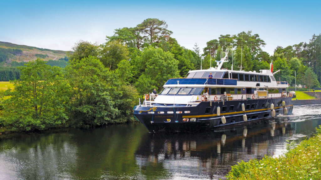 Ship Lord of the Glens cruises along the Caledonian Canal towards Fort Augustus, Scotland.