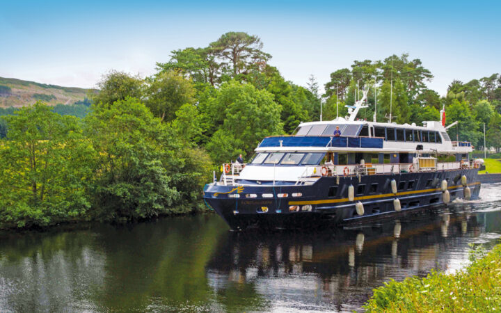 Ship Lord of the Glens cruises along the Caledonian Canal towards Fort Augustus, Scotland.