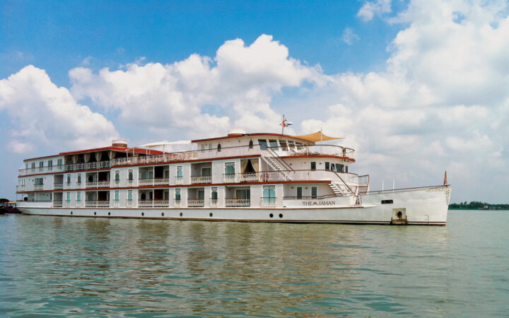 Jahan exterior anchored in Southeast Asia in calm waters and blue skys with white fluffy clouds as a backdrop.