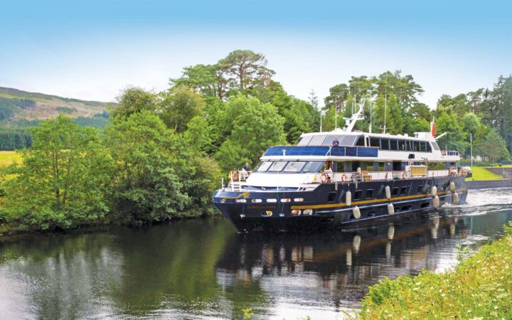 Ship Lord of the Glens cruises along the Caledonian Canal towards Fort Augustus, Scotland.