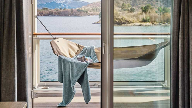 Balcony featuring a hammock with a lightweight blanket featuring a beautiful view of Chilean fjords as you pass on to Antarctic