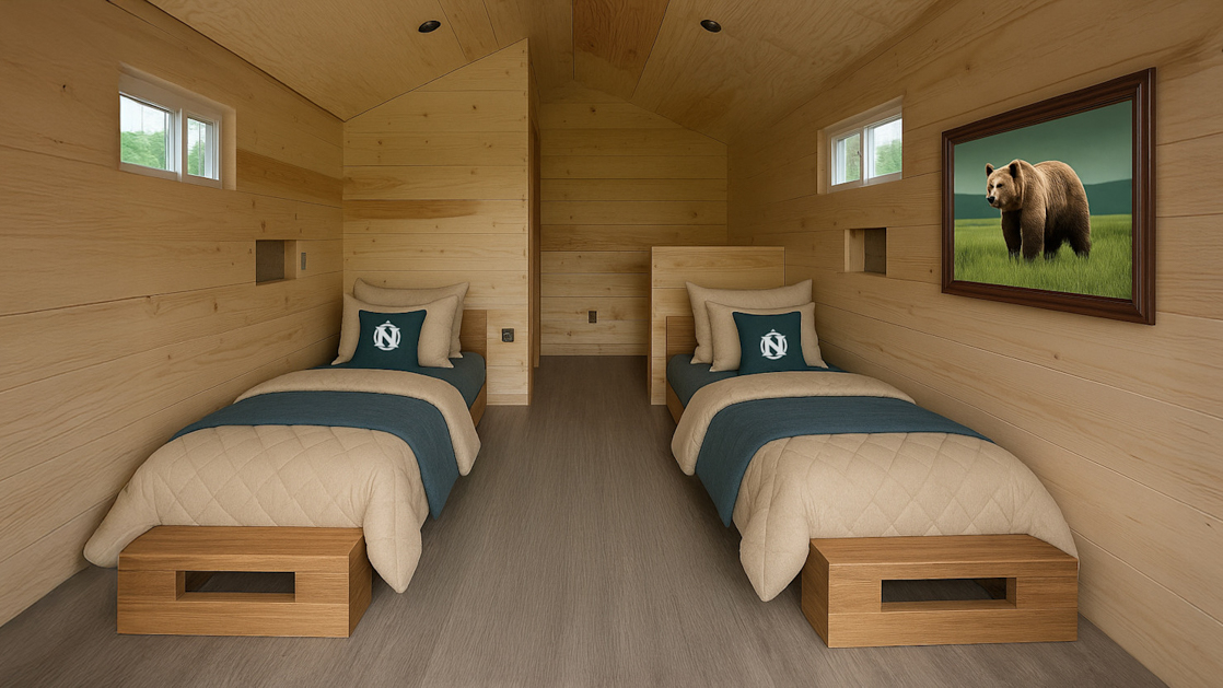 Wood cabin with two twin beds, tan bedding and grey pillows, with a photo of a bear and small windows