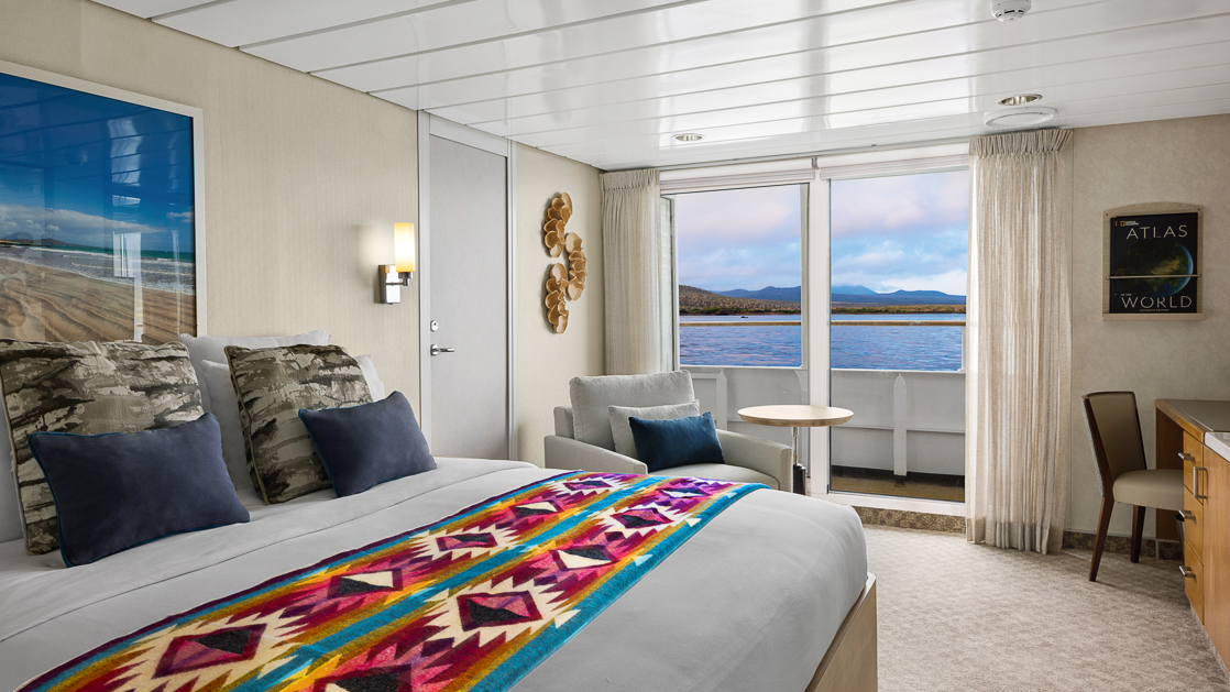Room about national geographic ship with double bed and large sliding glass doors