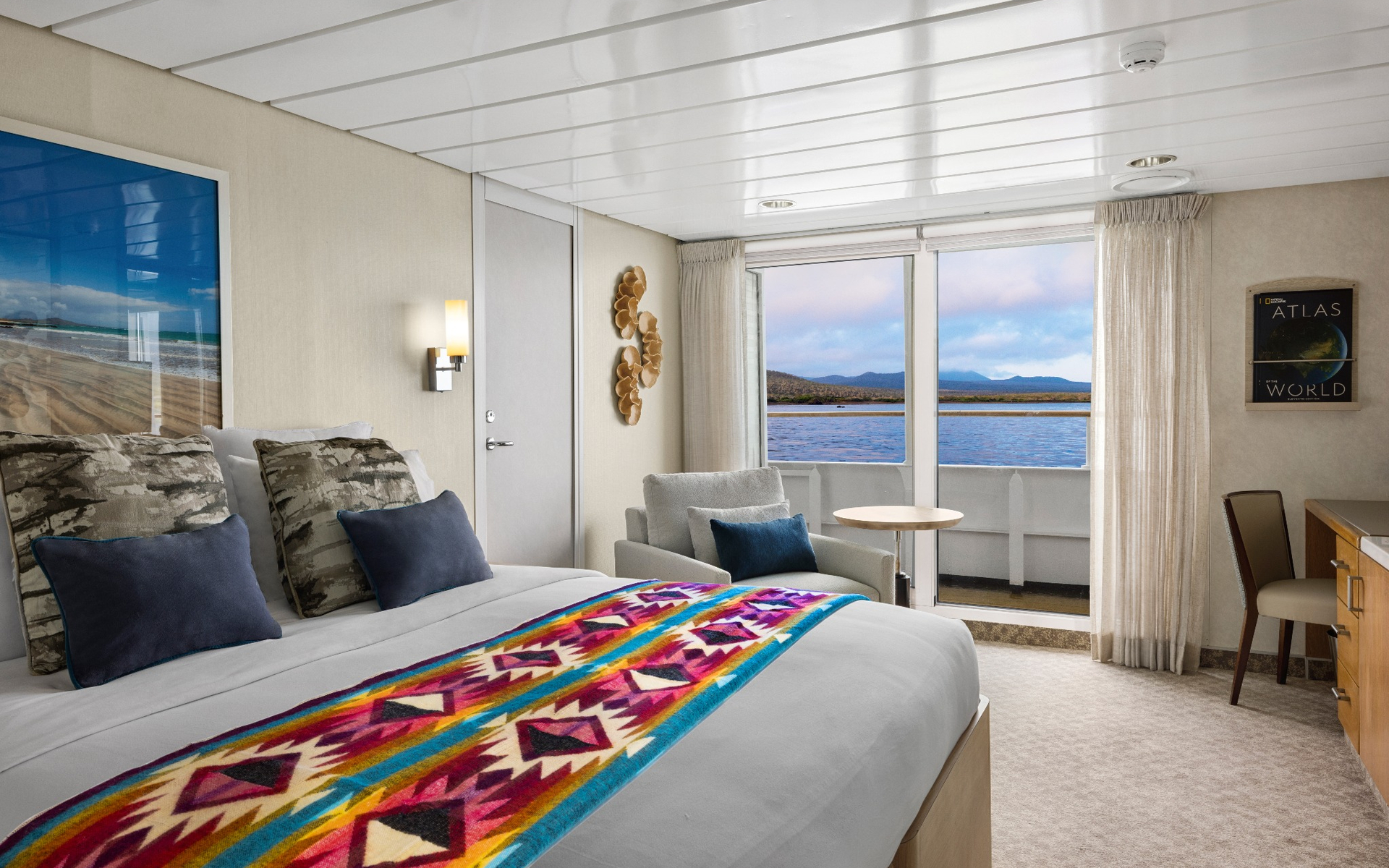 Room about national geographic ship with double bed and large sliding glass doors