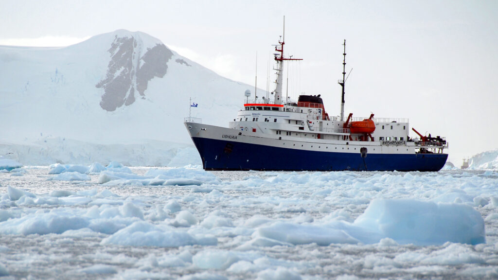 88 guest Ushuaia cruising through the icy polar waters of antarctica next to the snow covered mountains