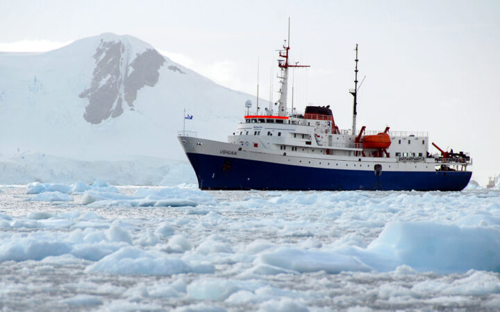 88 guest Ushuaia cruising through the icy polar waters of antarctica next to the snow covered mountains