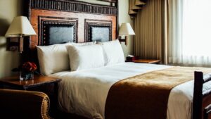 Executive Suite with large bed and wood bed frame at Talkeetna Lodge in Alaska.