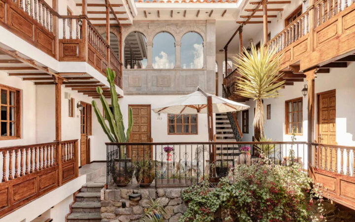 Courtyard of Andenes Boutique Hotel with wood accents and green plants for a calm and historic look
