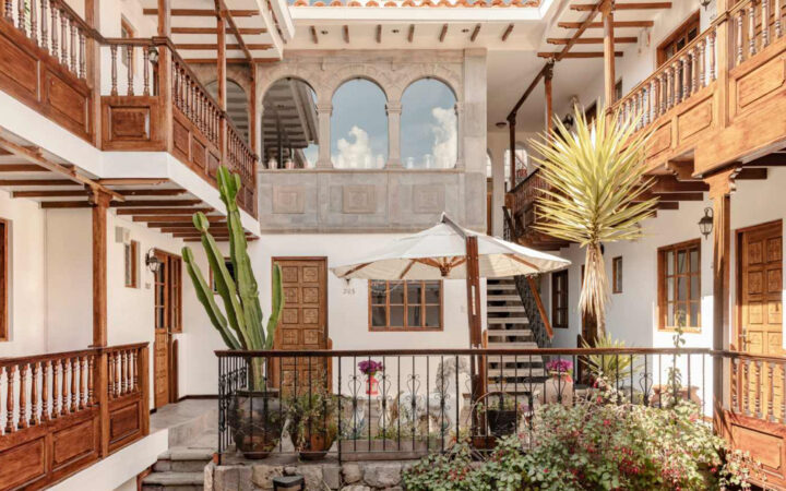 Courtyard of Andenes Boutique Hotel with wood accents and green plants for a calm and historic look