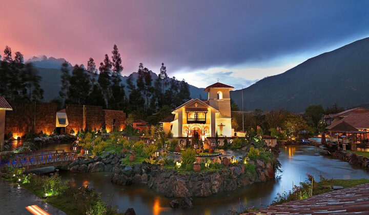 Beautiful entry way to the Aranwa sacred valley hotel & wellness with a pink and purple sunset off in the distance