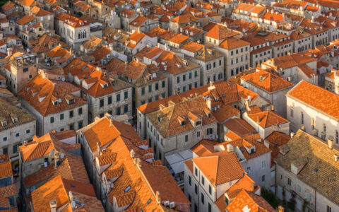 Aerial view of terra cotta roofs on beige stone buildings in Dubrovnik, Croatia, seen on a Valletta to Venice cruise.