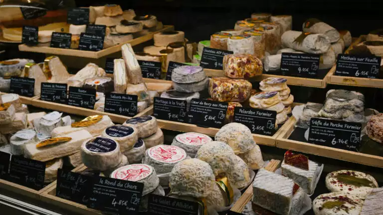 Case of various fine French cheeses, seen at a market on the Traversing the Med: A Mediterranean Feast small ship cruise.