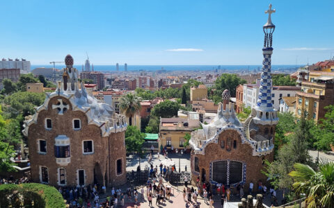 Iconic park in Barcelona Spain with beauitful buildings and mosaics on a bright sunny day.