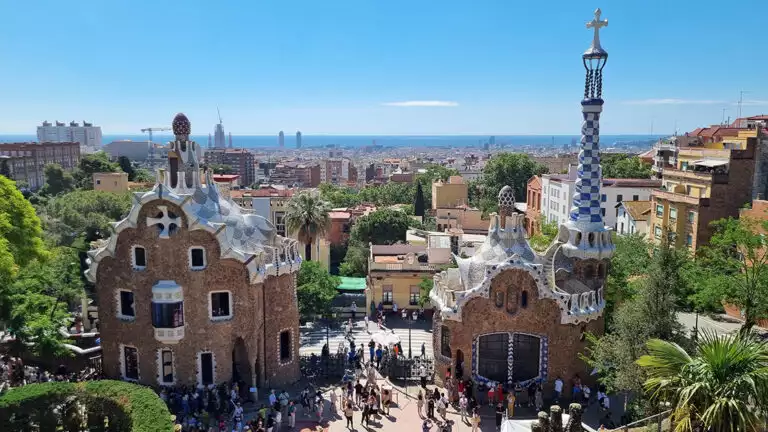 Iconic park in Barcelona Spain with beauitful buildings and mosaics on a bright sunny day.