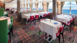 Dining room with tables, chairs and large viewing windows.