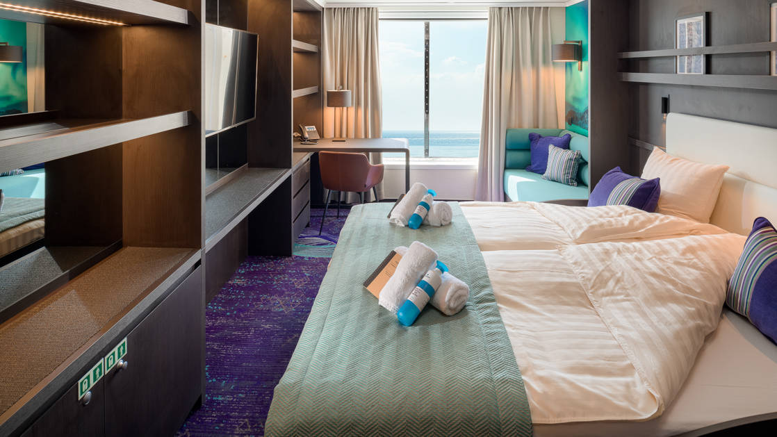 Junior Suite aboard Hondius and Janssonius polar small ships, with double bed, TV, large picture window and seating area.