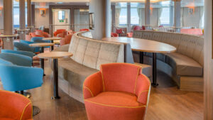 Hondius and Janssonius Observation Lounge with tables, chairs, bench seating and large viewing windows.