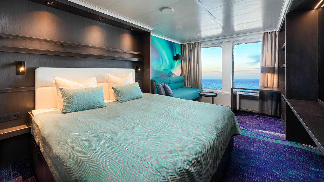 Hondius and Janssonius Superior Cabin with double bed, seating, 2 large windows, nightstand and night lights.