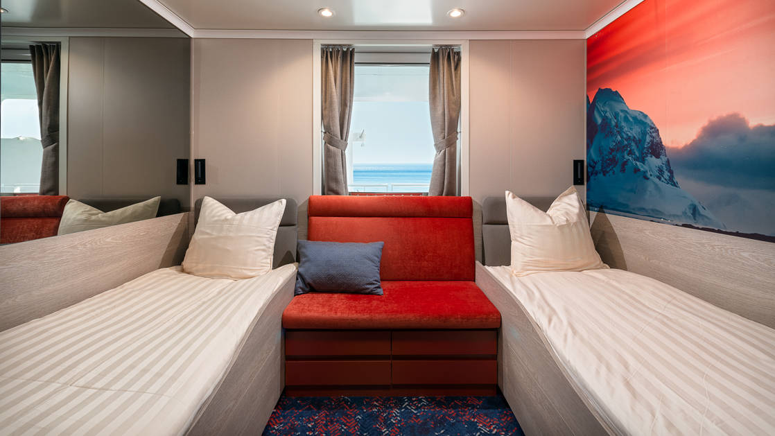 Hondius and Janssonius Twin Window stateroom with 2 berths, seating and window.
