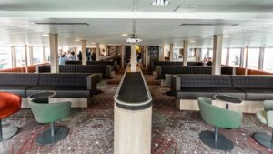 plancius polar expedition ship lounge with couches and tables filling the room and windows on the end