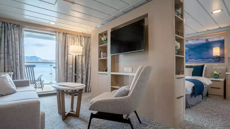 Lounge area in suite with couch and sitting area aboard small cruise ship in antarctica