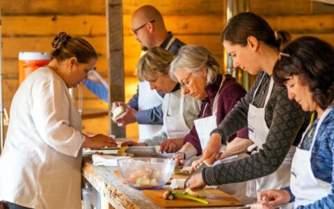 small group in a cooking class with the chef at tutka bay lodge in alaska