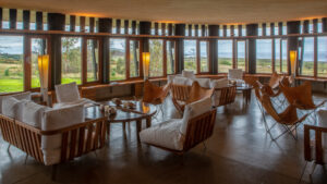 Comfortable chairs and couches in a sun-filled common room at Explora Rapa Nui Lodge on Easter Island