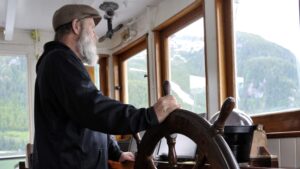 Captain at the wheel navigating Catalyst.