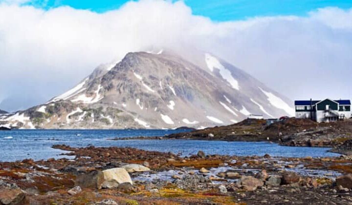 Hotel Kulusuk stands on a rocky bluff, near the water, with dramatic views of Apusiaajik Glacier and Isikajia Mountain in Greenland