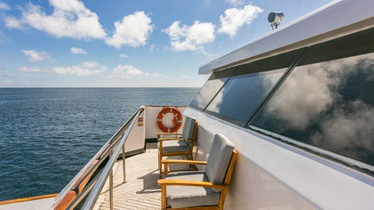 Seating area on the top of a small ship cruise overlooking the open ocean off the Galapagos Islands