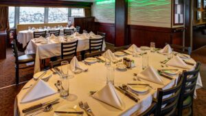 Three set tables in the dining room aboard Alaskan Dream.