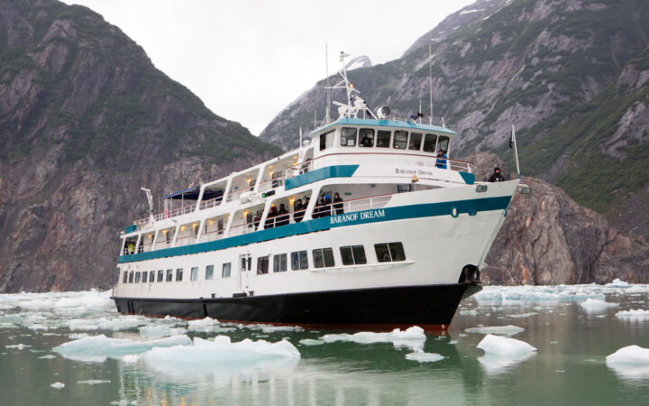 Bow of Baranof Dream cruising in Alaskan fjords with ice around.