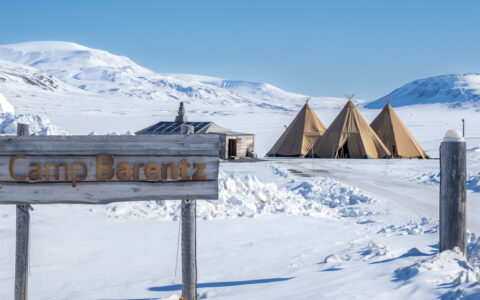 Camp Barentz with a backdrop of Snowy landscapes in the Artric during a landcruise